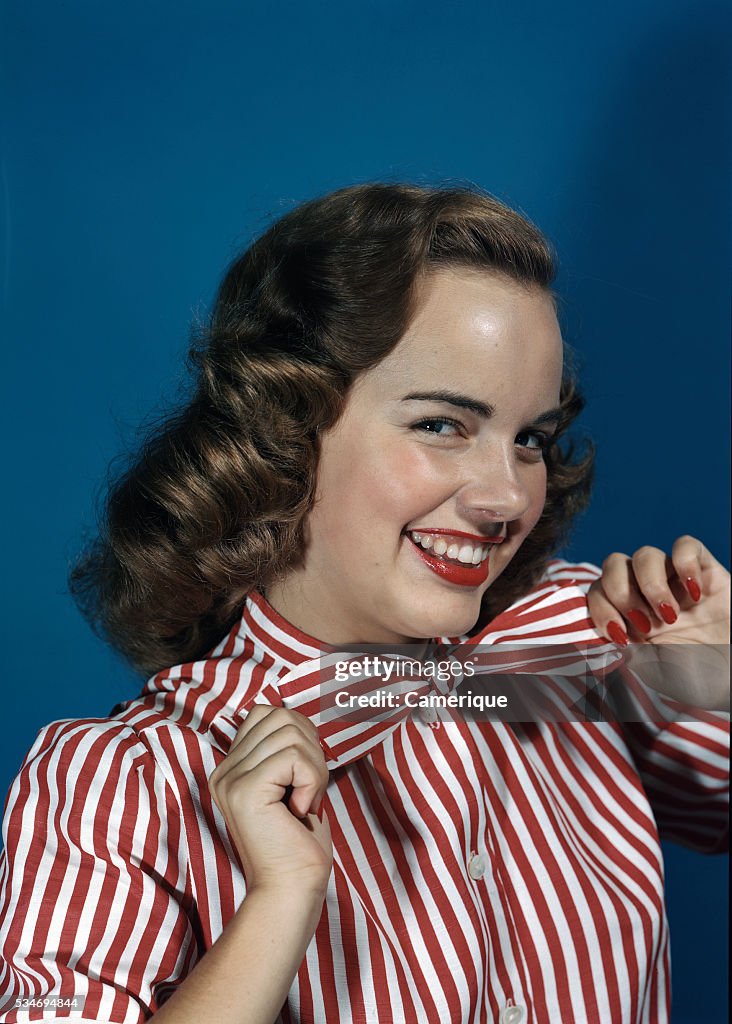 Actress Terry Moore In Red Striped Blouse Tugging On Bowtie