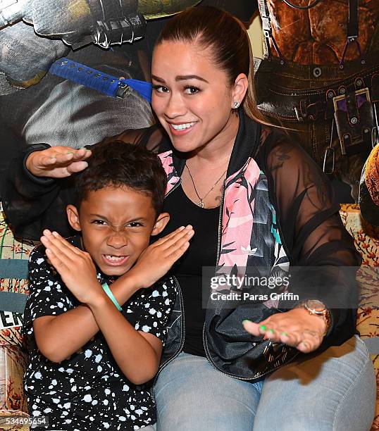 Sarah Vivan and her son Dwayne Michael Carter III attend "Teenage Mutant Ninja Turtles: Out Of The Shadows" Atlanta screening at AMC Phipps Plaza on...