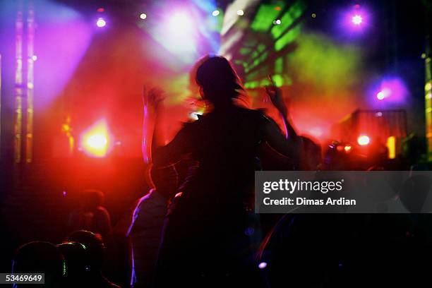 Clubbers attend a large dance party at GWK Cultural Park early August 27, 2005 in Jimbaran, Bali, Indonesia. Bali's nightclub scene is starting to...