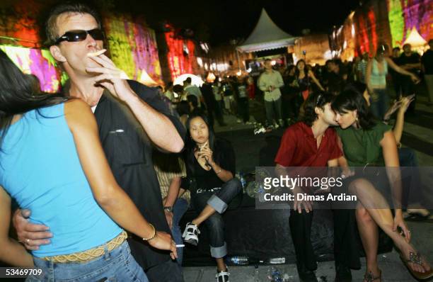 Clubbers attend a large dance party at GWK Cultural Park early August 27, 2005 in Jimbaran, Bali, Indonesia. Bali?s nightclub scene is starting to...
