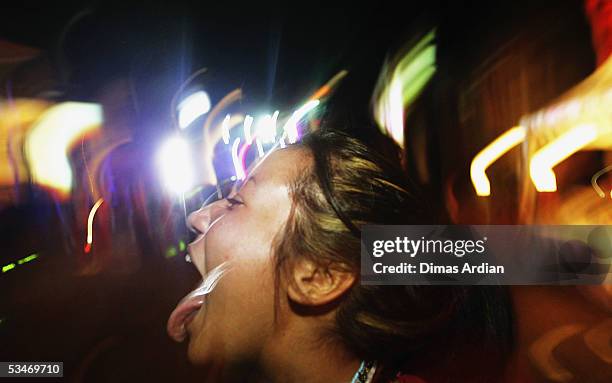 Clubbers attend a large dance party at GWK Cultural Park early August 27, 2005 in Jimbaran, Bali, Indonesia. Bali?s nightclub scene is starting to...