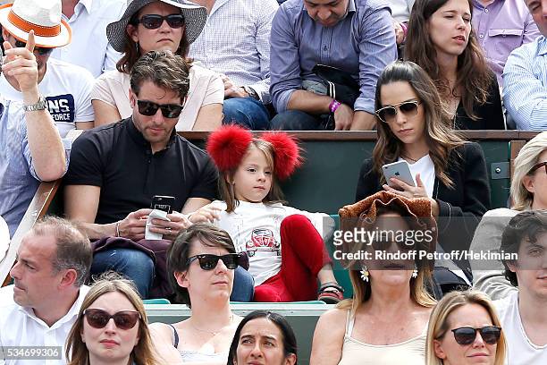 Brazilian Football player of PSG, Maxwell with his wife Giulia Andrade and their daughter attend the 2016 French Tennis Open - Day Six at Roland...