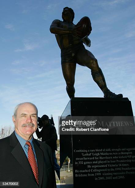 Current Brisbane Lions coach and AFL great Leigh Matthews poses with a bronze statue that was unveiled in his honor prior to the round 22 AFL match...