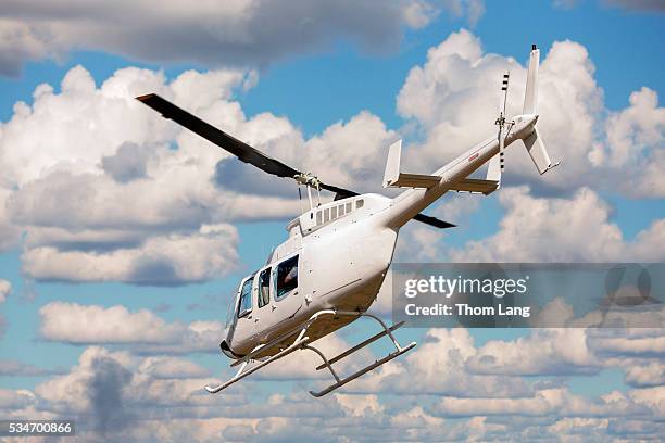 helicopter in blue sky with clouds - helicóptero - fotografias e filmes do acervo