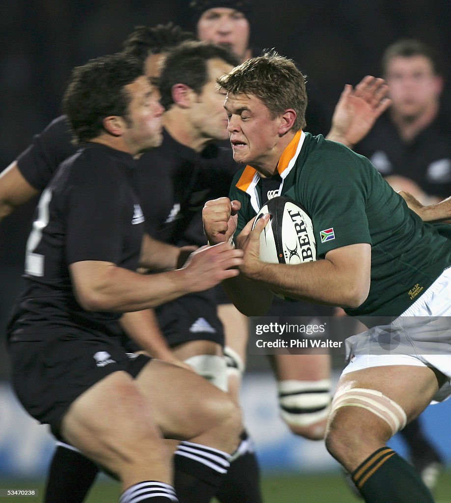 Springboks Tackle Springbok Juan Smith runs into the tackle of All Black Aaron Mauger ...