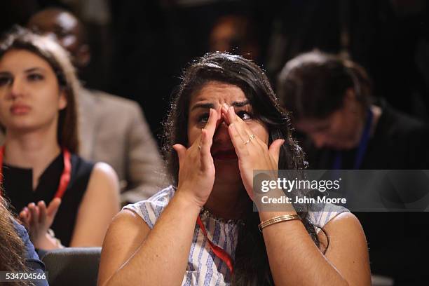 Iranian immigrant Sara Dinari wipes away tears of joy after becoming an American citizen at a naturalization ceremony on Ellis Island on May 27, 2016...