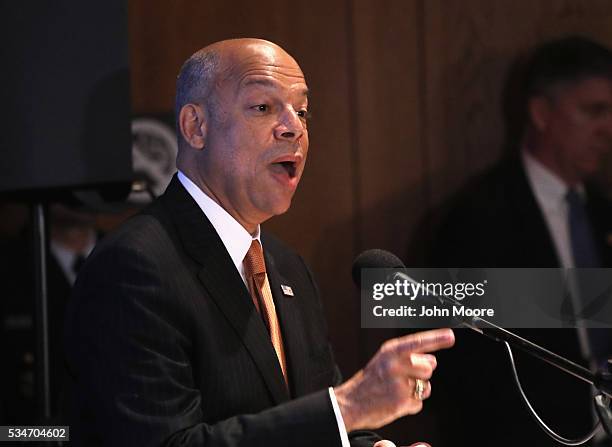 Secretary of Homeland Security Jeh Johnson speaks to a group of immigrants during a naturalization ceremony for new American citizens on Ellis Island...