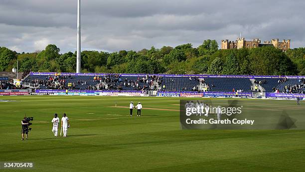 Chris Woakes and Moeen Ali of England leave the field at stumps on day one of the 2nd Investec Test match between England and Sri Lanka at Emirates...