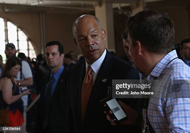 Secretary of Homeland Security Jeh Johnson speaks to a reporter following a naturalization ceremony for new American citizens on May 27, 2016 in New...