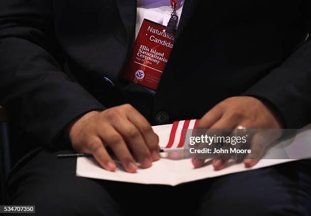 New American citizen takes part in a naturalization ceremony on Ellis Island on May 27, 2016 in New York City. U.S. Secretary of Homeland Security...