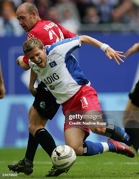 Jiri Stajner of Hanover competes with Benjamin Lauth of HSV during the Bundesliga match between Hamburger SV and Hanover 96 at the AOL Arena on...