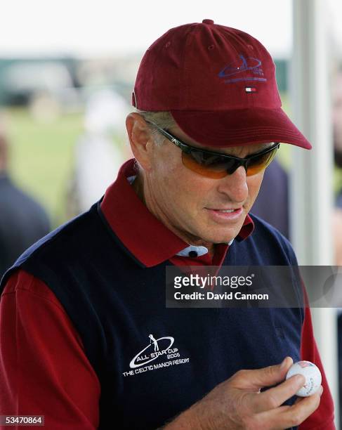 Michael Douglas of the USA examines his new ball during the Nearest the Pin Charity Challenge prior to the official photocall for the All-Star Cup on...