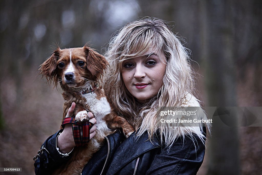 Young female walking her dog in woods