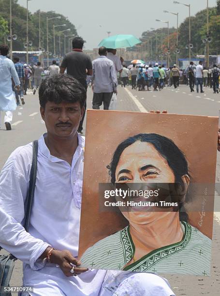 Supporter showing portrait of West Bengal Chief Minister Mamata Banerjee during her oath taking ceremony on May 27, 2016 in Kolkata, India. The...