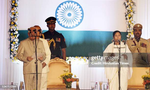 West Bengal Chief Minister Mamata Banerjee being administered oath by Governor Kesri Nath Tripathi at Red Road on May 27, 2016 in Kolkata, India. The...