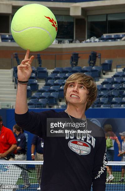 Actor/singer Jesse McCartney tries to spin the ball on his finger during media availability on Arthur Ashe Kids Day before the start of the 2005 US...