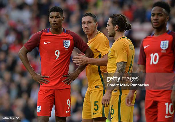 Marcus Rashford of England is tightly marked by Mark Milligan and Joshua Risdon of Australia defence during the International Friendly match between...