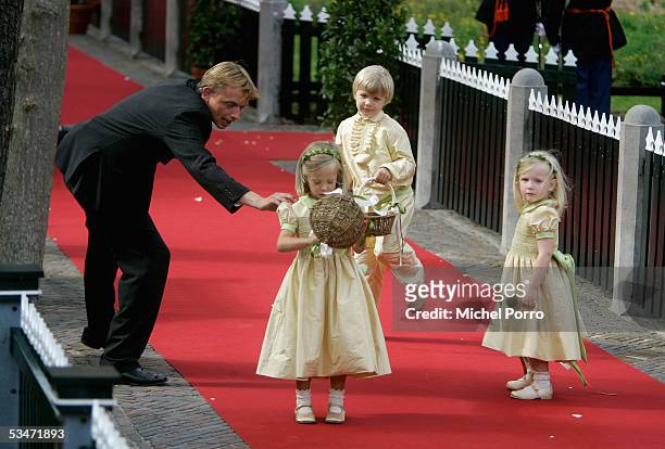 One of the bridesmaids children is pulled back after she wanted to prematurely empty her basket of flowers after the wedding of Prince Pieter...