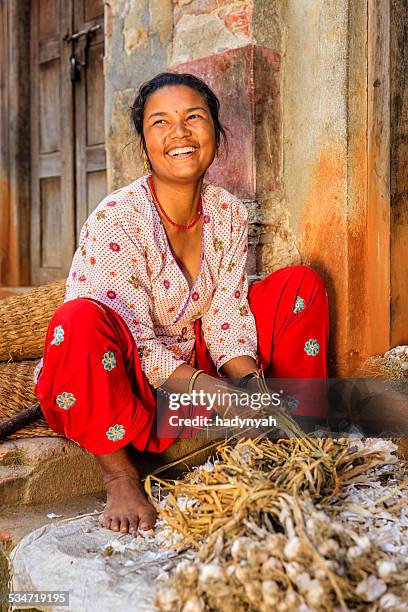 nepali woman picking over a garlic in bhaktapur, nepal - nepal people stock pictures, royalty-free photos & images