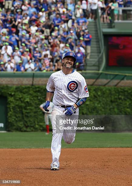David Ross of the Chicago Cubs smiles as he runs the bases after hitting the 100th home run of his career in 4th inning against the Philadelphia...