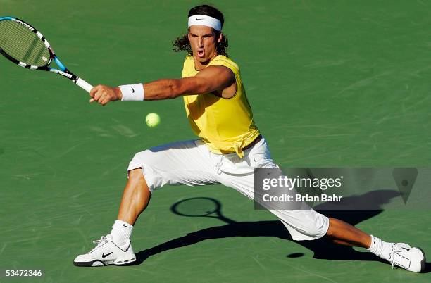 Feliciano Lopez of Spain slides to reach a volley from David Ferrer of Spain during the men's semifinals of the Pilot Pen Tennis tournament on August...