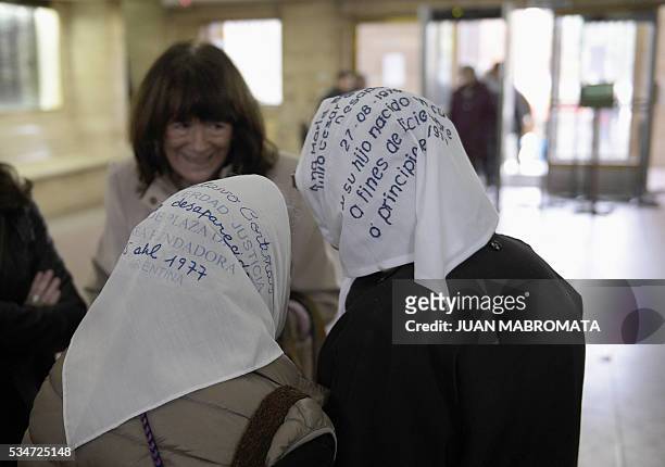 Members of human rights organization Madres de Plaza de Mayo Nora Cortinas and Mirta Baravalle, speaks with a woman as they wait to hear the sentence...