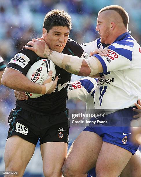 Luke Priddis of the Panthers is tackled by Mark O'Meley of the Bulldogs during the round 25 NRL match between the Bulldogs and the Penrith Panthers...