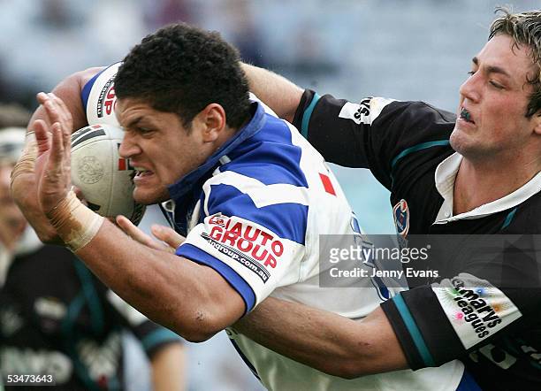 Willie Mason of the Bulldogs tackled by Trent Waterhouse of the Panthers during the round 25 NRL match between the Bulldogs and the Penrith Panthers...