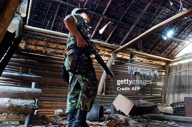 Soldier checks an abandoned hut suspected to be a hide out of Free Aceh Movement members after an armed clash at Muere Baro village in Indrapuri-Aceh...