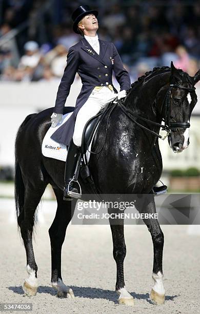 Dutchwoman Anky van Grunsven on her horse "Geldnet Lingh" breathes after the Grand Prix Dressage competition of the CHIO World Equestrian Festival in...