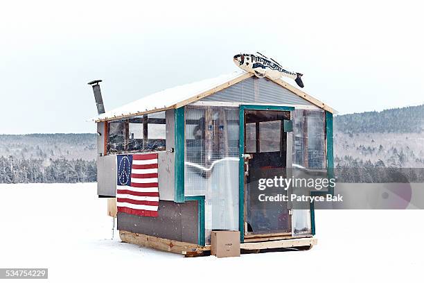 young man ice fishing in maine - fishing hut stock pictures, royalty-free photos & images