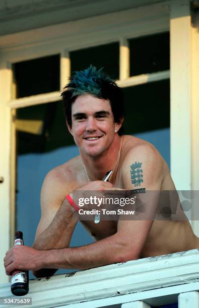 Kevin Pietersen of England points to his tattoo as he celebrates with a beer after winning the Fourth npower Ashes Test between England and Australia...