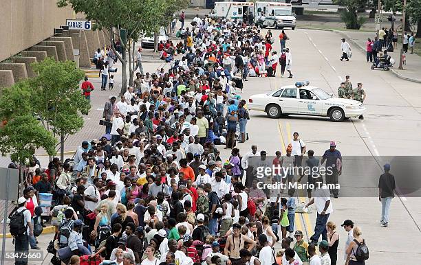 Residents wait in line to enter the Superdome which is being used as an emergency shelter before the arrival of Hurricane Katrina August 28, 2005 in...