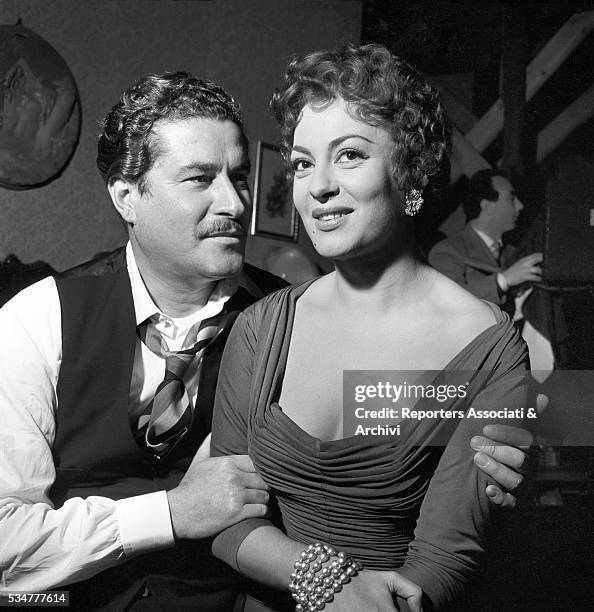 Italian actor Amedeo Nazzari hugging Greek-born Italian actress Yvonne Sanson during a break on the set of the film Nobody's Children. 1951