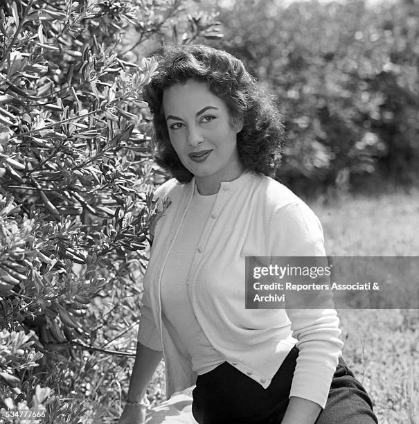 Greek-born Italian actress Yvonne Sanson posing in the garden of her villa on the Appian Way in Rome. Rome, 1955