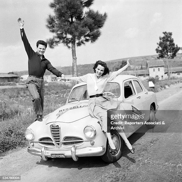Italian actors Franco Interlenghi and Antonella Lualdi posing on their Alfa Romeo 1900. Italy, 21st April 1955