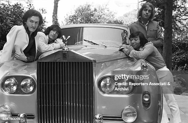 Musical band Equipe 84 posing next to a Rolls-Royce. Italy, 28th August 1966