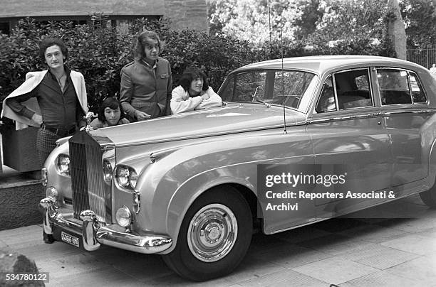 Musical band Equipe 84 posing next to a Rolls-Royce. Italy, 28th August 1966