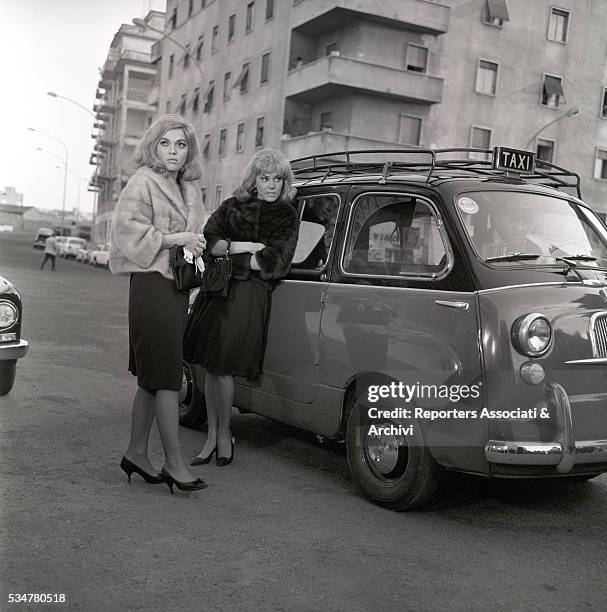 Italian actresses Valeria Fabrizi and Maria Grazia Spina posing on the set of a movie. Italy, 1964