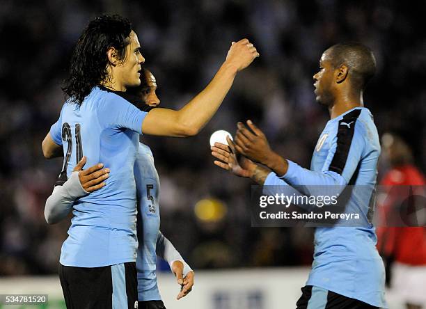 Edinson Cavani, Carlos Sanchez and Diego Rolan celebrate their team's first goal during an international friendly match between Uruguay and Trinidad...