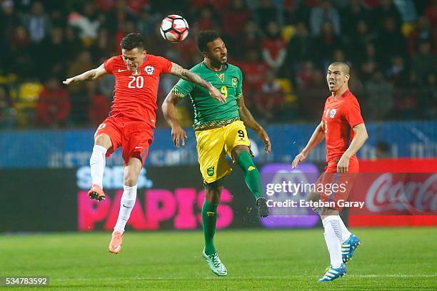 Charles Aranguiz of Chile fights for the ball with Giles Barnes of Jamaica during an international friendly match between Chile and Jamaica at...