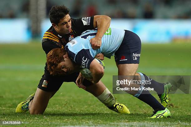 Anton Lienert-Brown of the Chiefs tackles Andrew Kellaway of the Waratahs during the round 14 Super Rugby match between the Waratahs and the Chiefs...