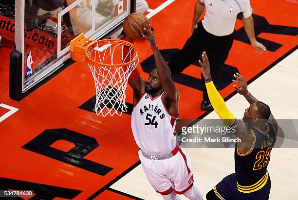 Patrick Patterson of the Toronto Raptors shoots against LeBron James of the Cleveland Cavaliers in the first half in game six of the Eastern...