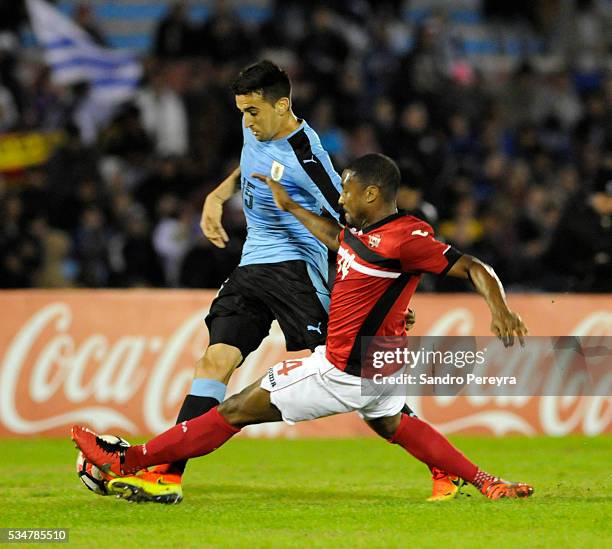 Matias Vecino of Uruguay and Andre Boucaud of Trinidad Tobago fight for the ball during an international friendly match between Uruguay and Trinidad...