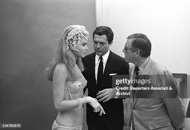 Italian actor Marcello Mastroianni and American actress Pamela Tiffin dressed as an odalisque speaking on the set of the film The Man, the Woman and...