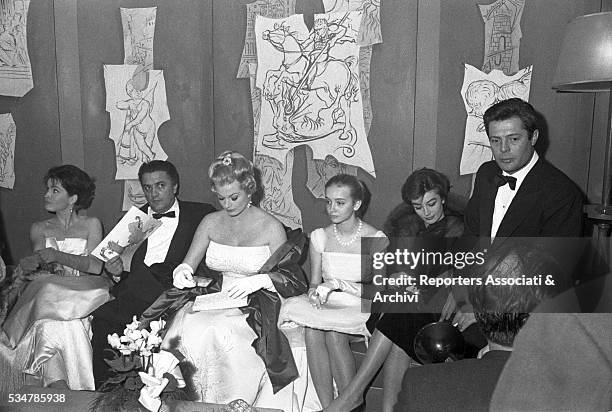 Italian actor Marcello Mastroianni, Italian director Federico Fellini, Swedish-born Italian actress Anita Ekberg and French actress Anouk Aimée at...