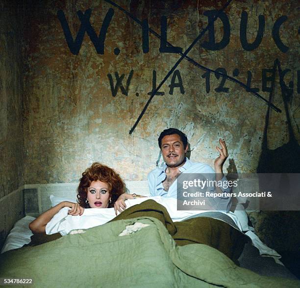 Italian actors Marcello Mastroianni and Sophia Loren lying in bed in the film Marriage Italian Style. 1964