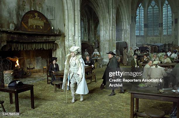 Italian actor Marcello Mastroianni - acting Giacomo Casanova - and German actress Hanna Schygulla in a church housing a canteen in the film That...