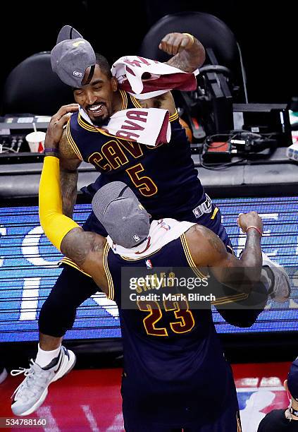 LeBron James and J.R. Smith of the Cleveland Cavaliers celebrate their 113 to 87 win over the Toronto Raptors in game six of the Eastern Conference...