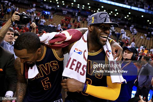 LeBron James and J.R. Smith of the Cleveland Cavaliers celebrate their 113 to 87 win over the Toronto Raptors in game six of the Eastern Conference...